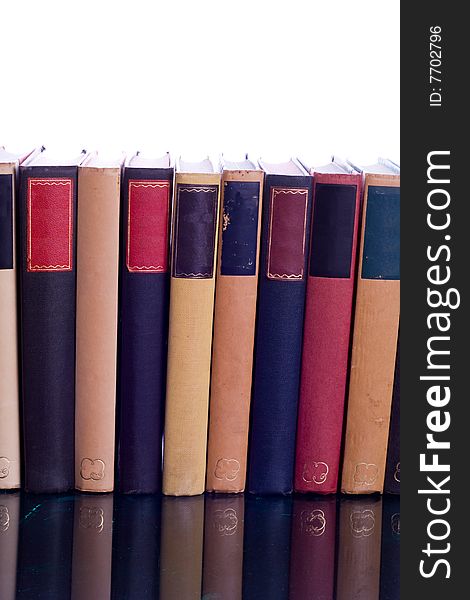 Set of books with assorted colored bindings on reflected surface. Set of books with assorted colored bindings on reflected surface