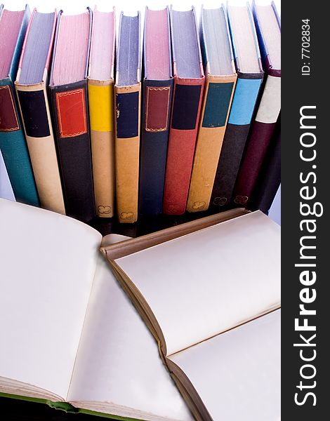 Collection of books with assorted colored bindings with open blank pages. Collection of books with assorted colored bindings with open blank pages