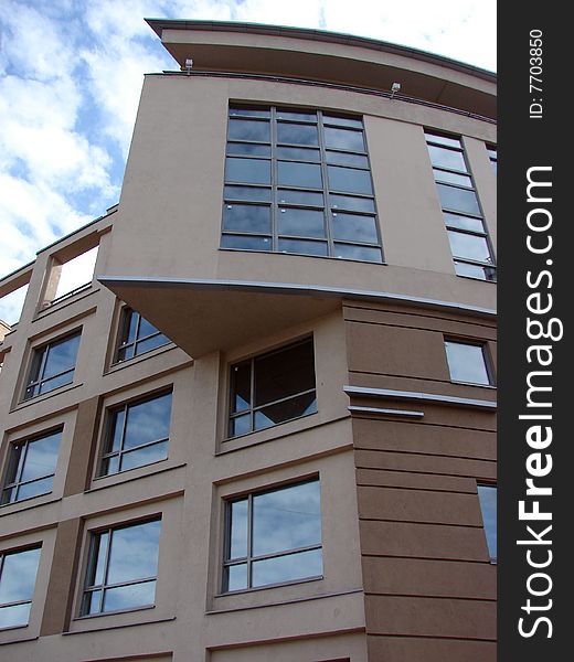 High building modern architecture from glass and concrete on a background of the dark blue sky