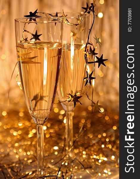 Two glasses of champagne od gold background. Two glasses of champagne od gold background
