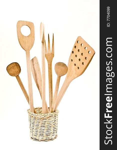 A wood pot of kitchen utensils on the white background.