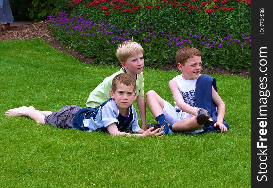 A photograph of three boys playing in summer