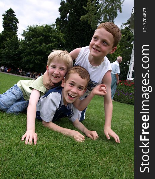 A photograph of three boys playing in summer