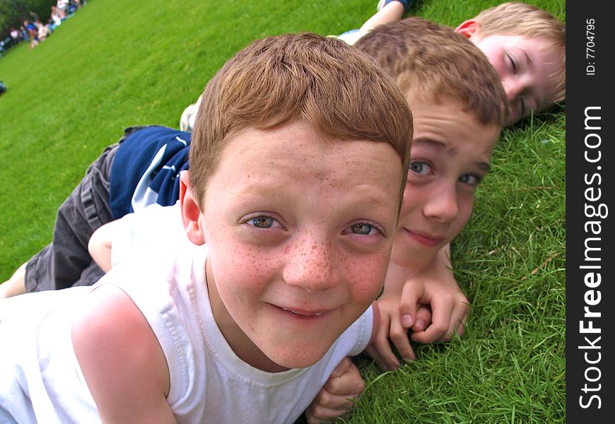 A photograph of three boys playing in summer