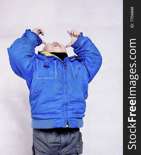 A picture of a chinese little boy laughing and facing upward