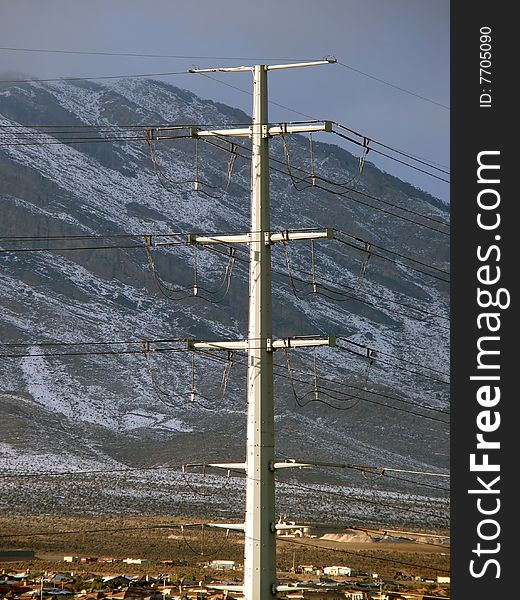 Electrical lines in front of snowy mountain