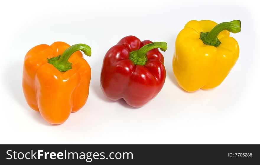 Three colored peppers isolated on white