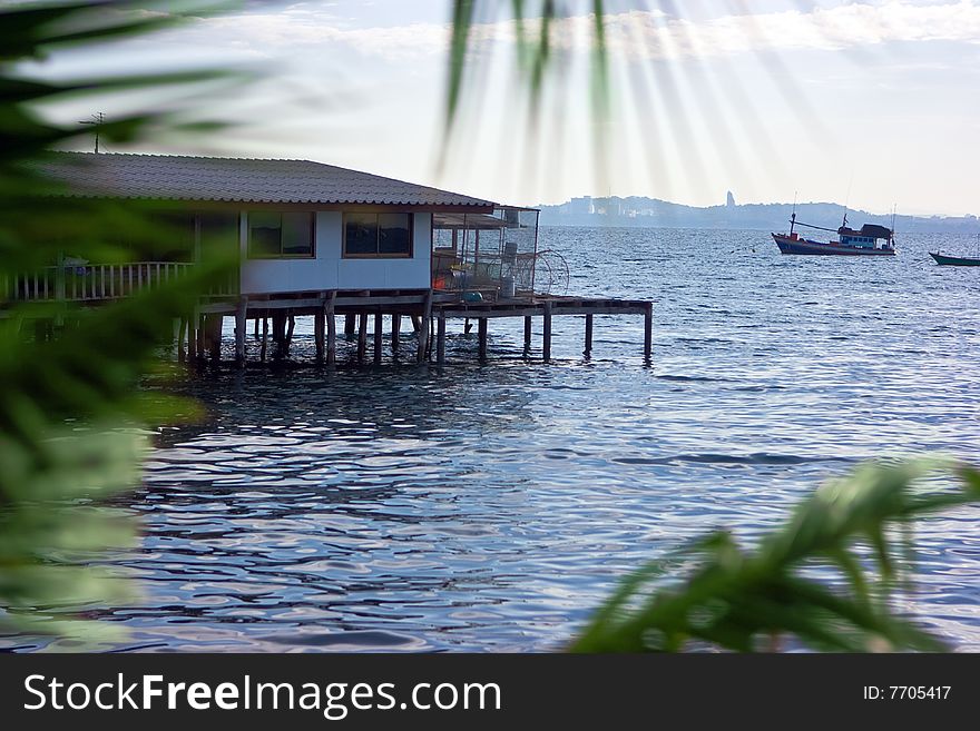 Fishing village house standing on piles in the sea