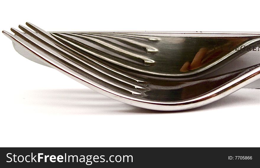 Stainless steel cutlery knife and fork isolated on a white background. Stainless steel cutlery knife and fork isolated on a white background