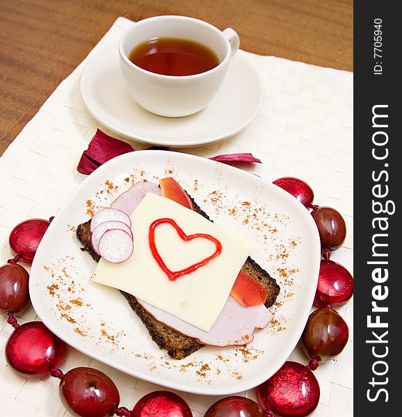 Valentines sandwich with a tea on a table. Valentines sandwich with a tea on a table