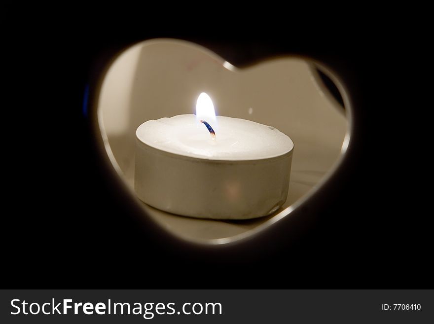 Burning candle in heart candlestick. Burning candle in heart candlestick