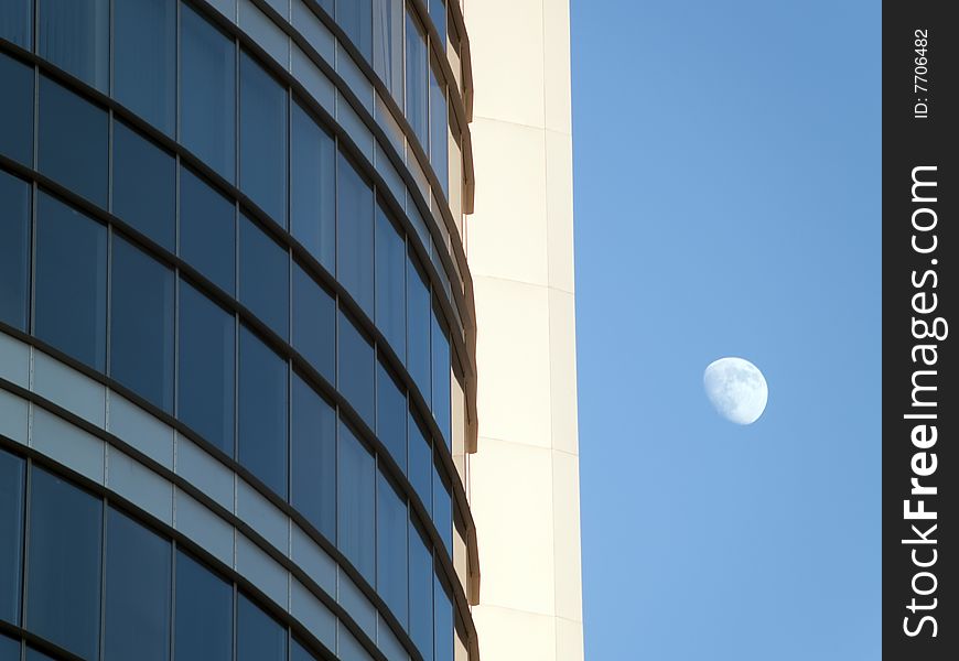Skyscraper's windows and moon in the sky. Skyscraper's windows and moon in the sky