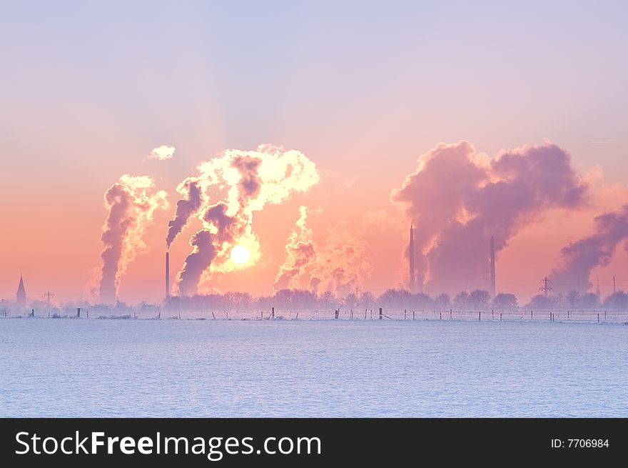 Nice winter landscape with industrial smokers with pale sunset. Nice winter landscape with industrial smokers with pale sunset