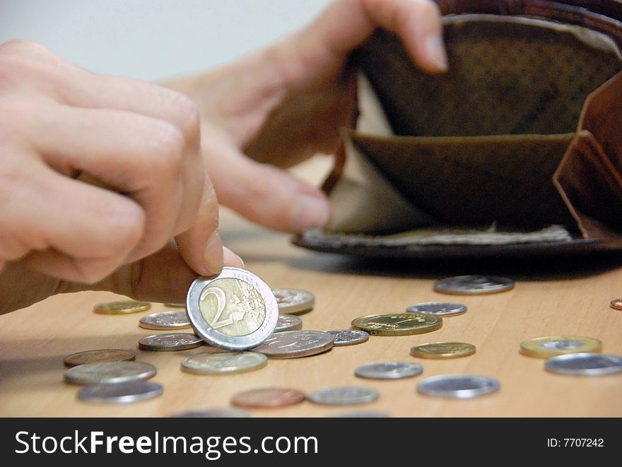 Woman considers coins in its purse