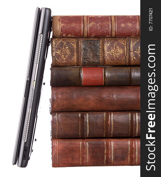 Old leather bound books with a laptop