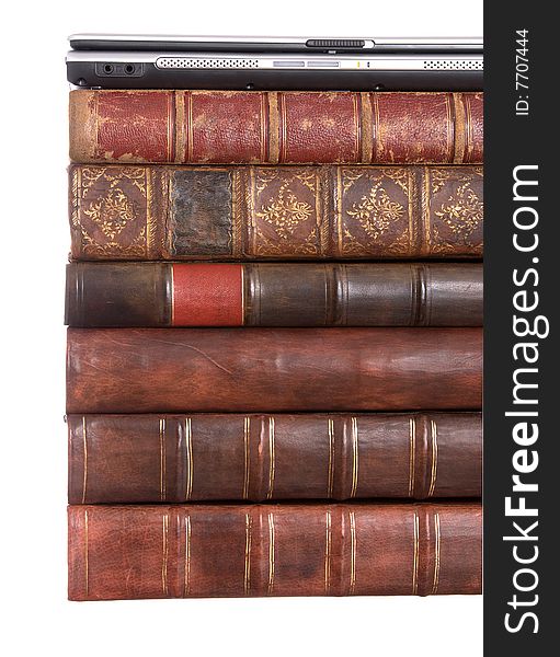 Old leather bound books with a laptop isolated on a white background