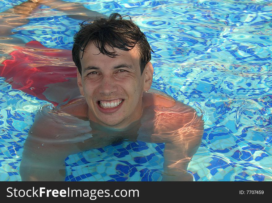 Man in red bathing trunks in the swimming pool. Man in red bathing trunks in the swimming pool