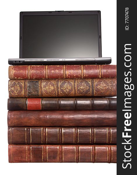 Old leather bound books with a laptop isolated on a white background