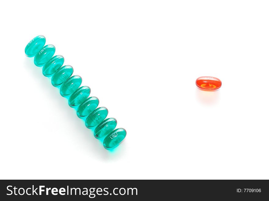 Single red pill and many green pills in a row