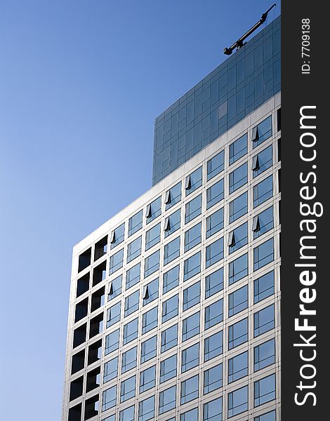 Windows by modern building in blue sky