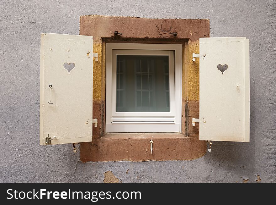 Old window in wall with shutters on both sides. Old window in wall with shutters on both sides