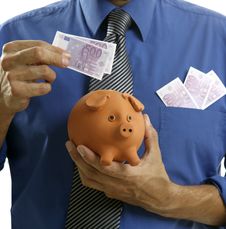 Businessman Insert Euro Notes In Piggy Bank Royalty Free Stock Image