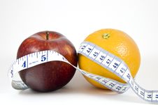 Apple And Orange Wrapped By Tape Measure Stock Photos Apple And Orange Wrapped By Tape Measure Stock Photos