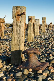 Groynes And Rusty Bollard Royalty Free Stock Image