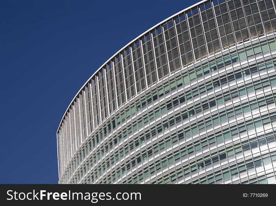 Windows by modern building in blue sky