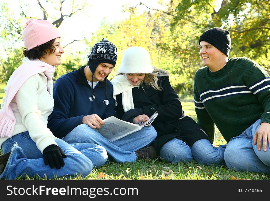 Four young caucasian male and female talking and having fun in park. Four young caucasian male and female talking and having fun in park