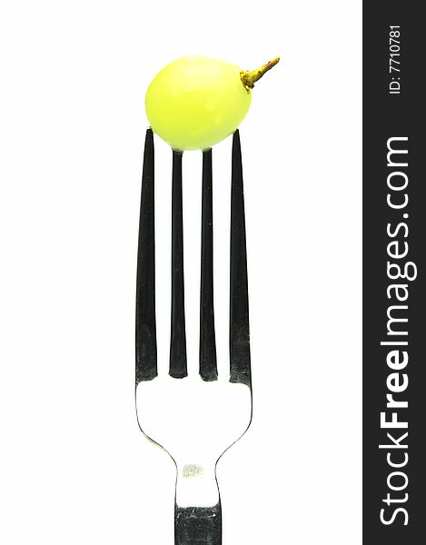 Grape on a fork isolated against a white background. Grape on a fork isolated against a white background