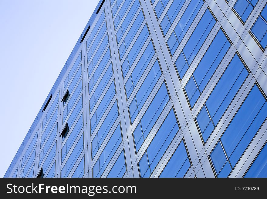 Windows by modern building in blue sky