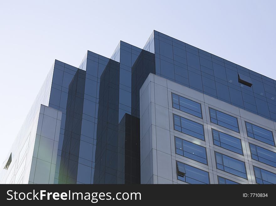 Windows by modern building in blue sky