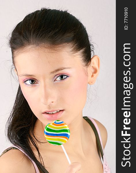 Portrait of brunette holding lollipop. Portrait of brunette holding lollipop.