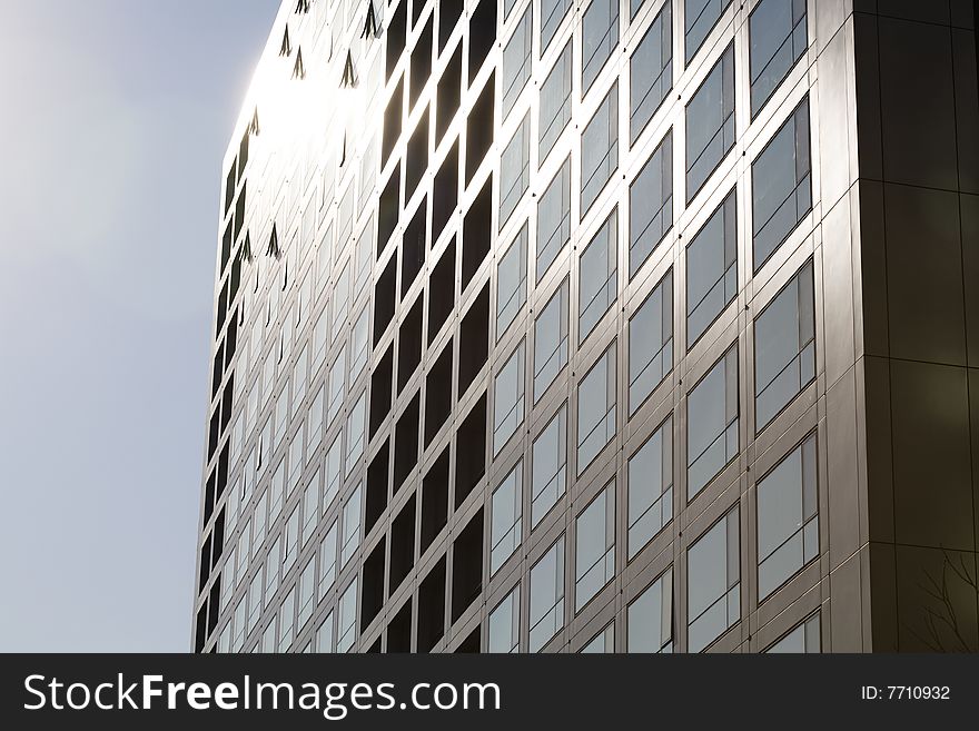 Windows by modern building in blue sky