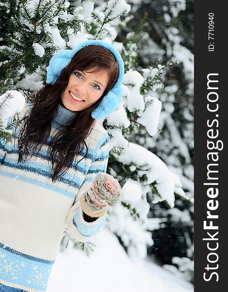 Beautiful girl wearing sweater and jeans on the winter background. Beautiful girl wearing sweater and jeans on the winter background.
