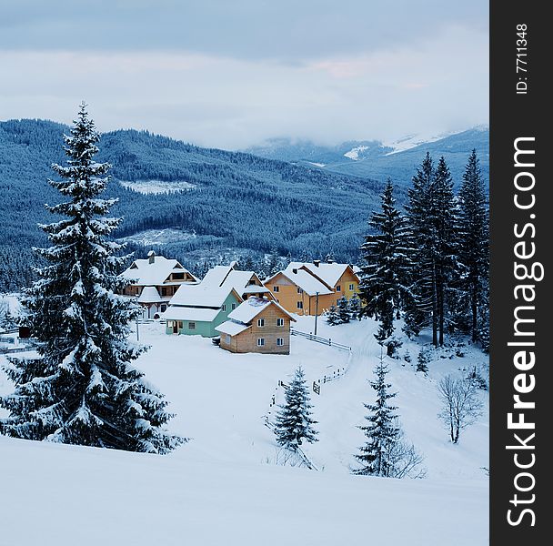 Stock photo: an image of a village in a winter forest. Stock photo: an image of a village in a winter forest