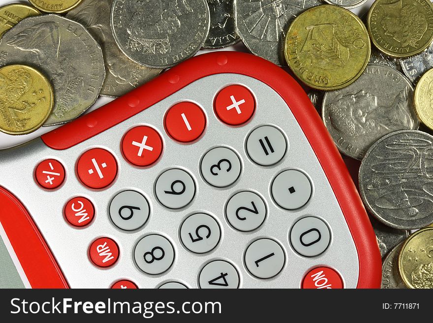 red and silver calculator with Australian dollar coins around it. red and silver calculator with Australian dollar coins around it