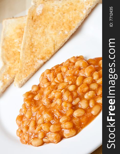 Delicious baked beans on toast on a plate