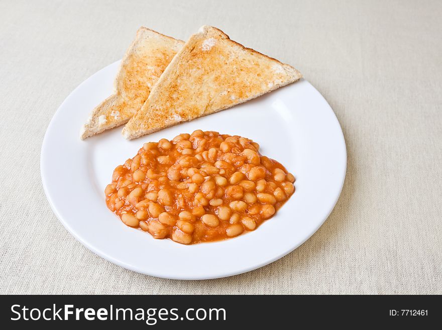 Delicious baked beans on toast on a plate