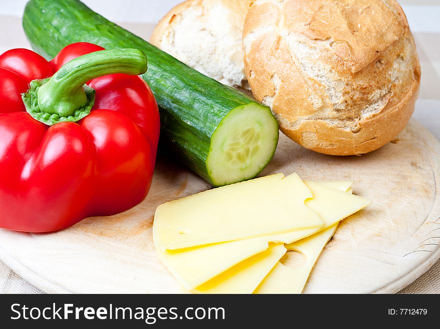 Delicious ham, cheese and salad sandwich on a wooden board