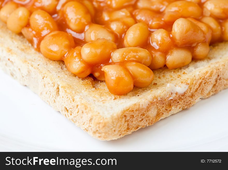 Delicious baked beans on toast on a plate