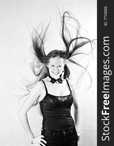 Wind. Portrait of beautiful smiling girl. Black and white classical photo