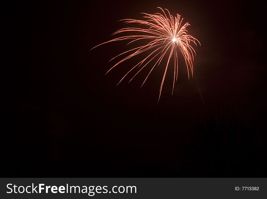 Fireworks, red star burst at the black sky on new years eve