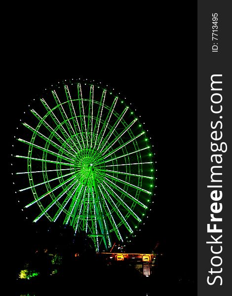 A running ferris wheel whith colour light on at night. A running ferris wheel whith colour light on at night