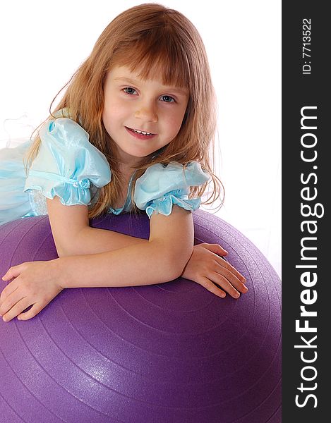 A 4 year old girl with a big violet ball. A 4 year old girl with a big violet ball