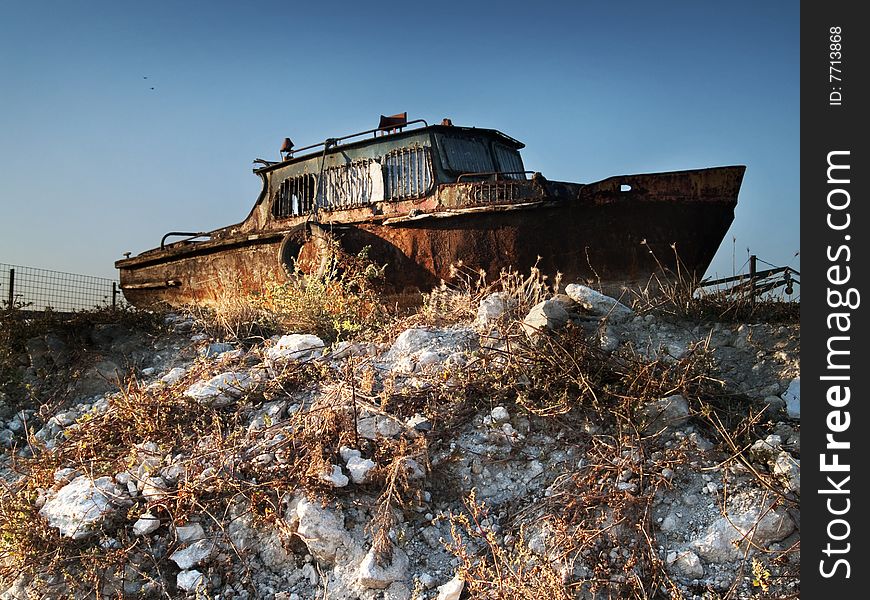 Rusty ship in the junkyard