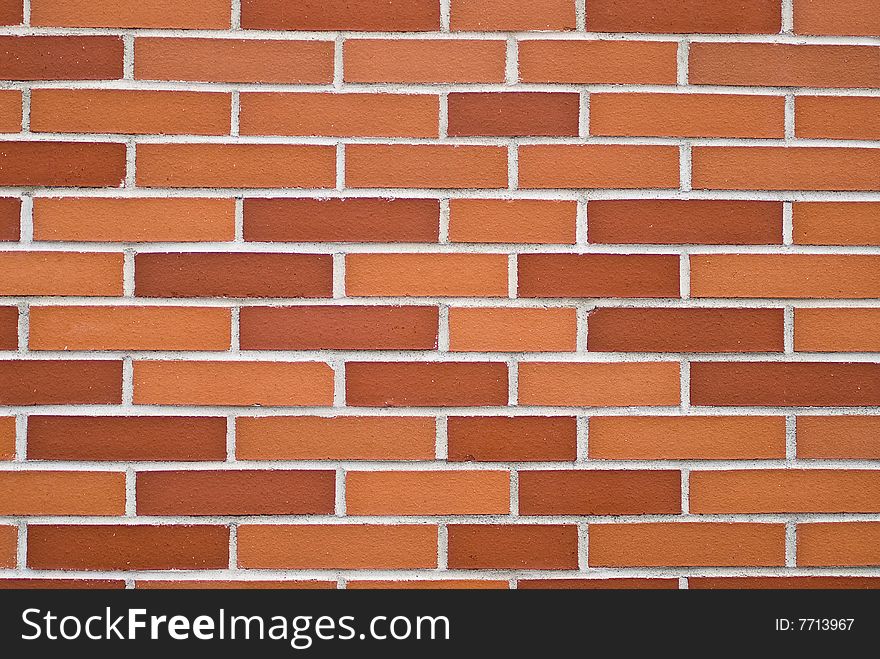 A brickwall with stones in shades of red and orange