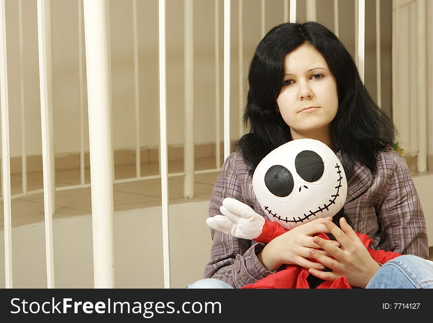 Sad teenager with a doll