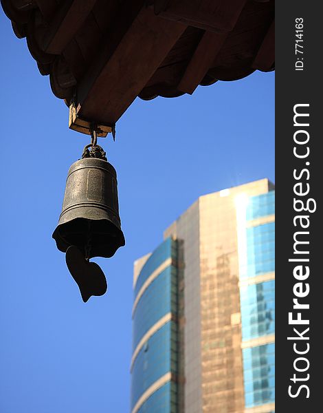 Temple bell and building with blue sky.